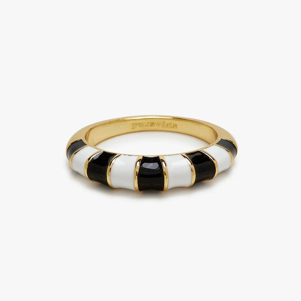Ring is laying on flat surface. Black and white enamel stiripe wth thin gold stripes separately the 2 colors. "Pura Vida" is etched  on the inside.