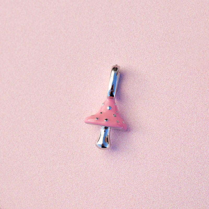Pink and silver charm on a pink background