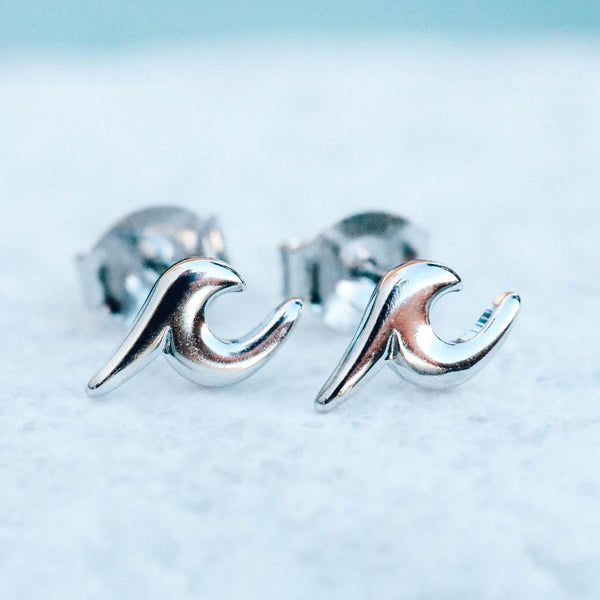 shows a silver pair of stud earrings with a wave symbol and metal backings