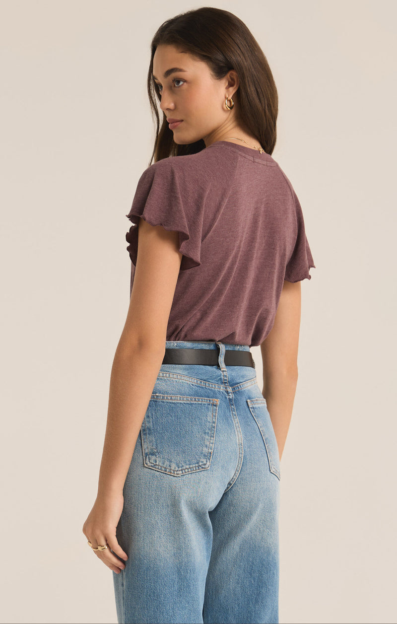 back view of the model wearing the crew neckline. also shows the flutter sleeve detail and the relaxed fit. 