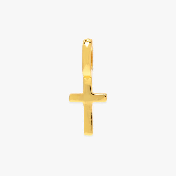 Gold cross pendant on a white background