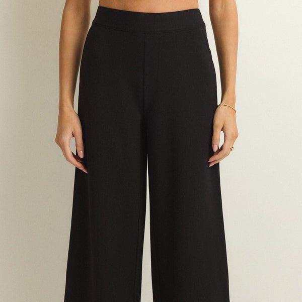front view of the model wearing the do it all trouser pant. shows the high waist of the pant. also shows fauz front pockets, and the regular fit. 