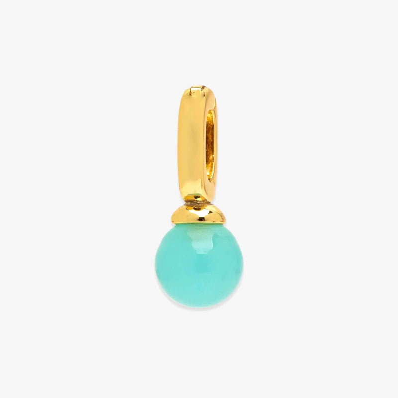 Gold pendant with a turquoise bead on a white background