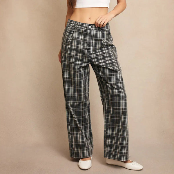 front view of the sawyer pants. shows the mid rise. also shows the front pleats, the plaid print, and the wide legs. 