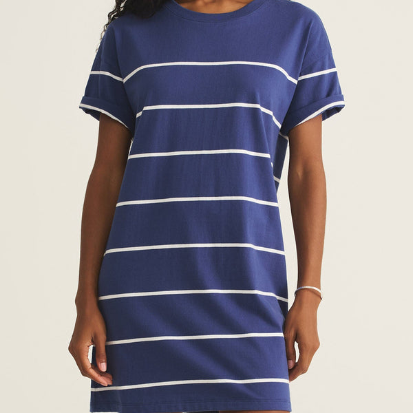 front view of the model wearing the sway stripe mini dress. shows the white stripes. also shows the scoop neckline, the relaxed fit, and the midi length and short sleeves. 