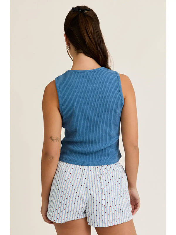 back view of the model wearing the horseshoe tank. shows the fitted style. also shows the blue color of the tank, the ribbed detailing. 