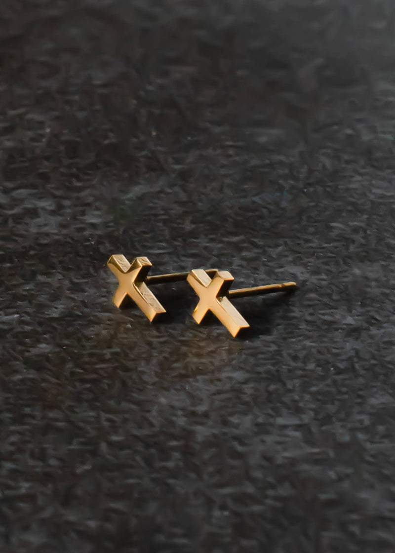 front view of the cross stud earrings. shows the gold cross, and the post. 