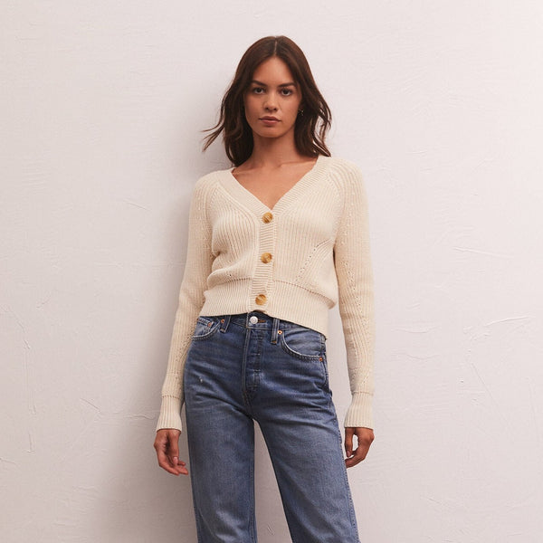 front view of cardigan. shows the v-neckline with buttons down the front, cropped length and knitted detail.