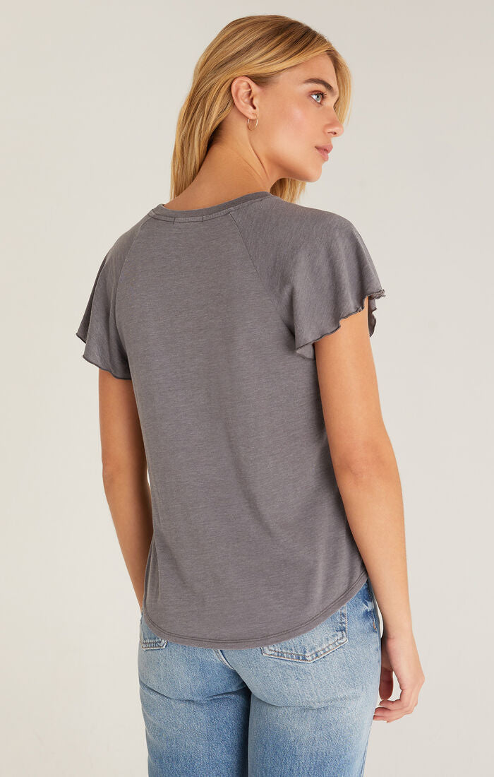 Back view of shirt. Shows raglan flutter sleeves and curved hemline.