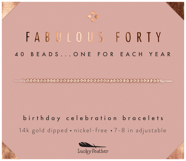 'Fabulous Forty' bracelet with gold text on a pink background
