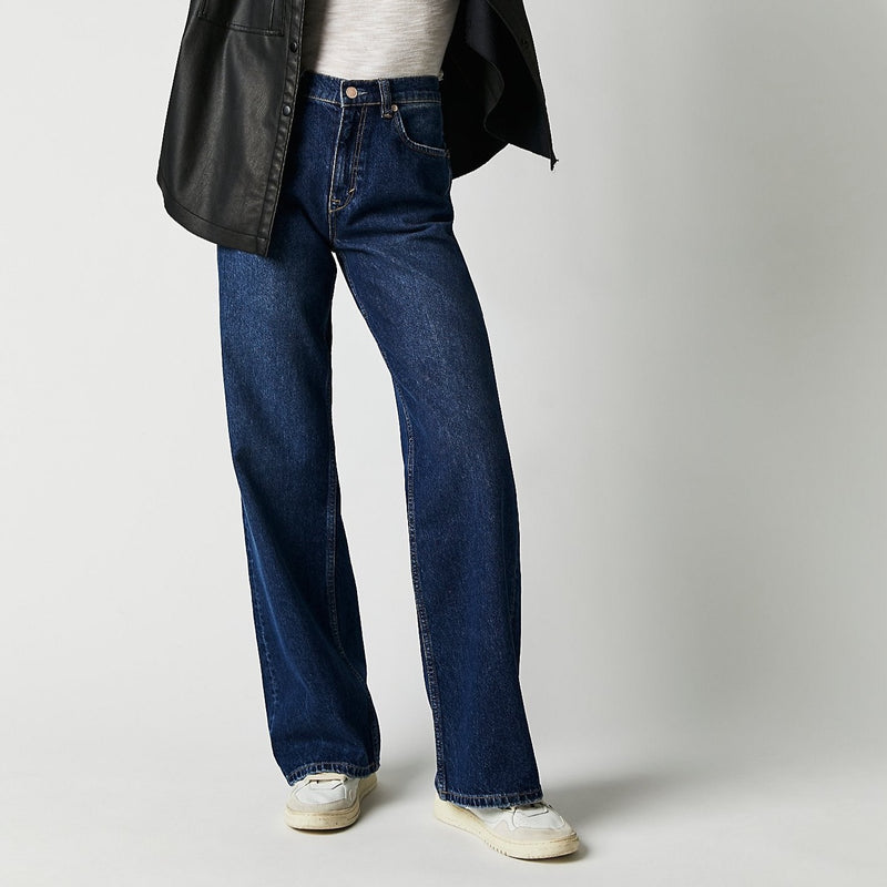 Front view of model wearing jeans. Shows the button closure. Also shows the high rise of the jeans and the straight , baggy leg.