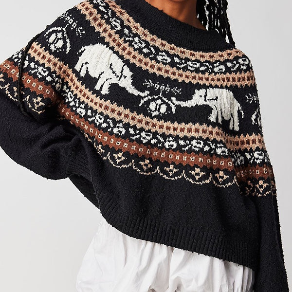 Front view of model wearing sweater. Shows The scoop neckline. Also shows the slouchy fit and ribbed hems. 