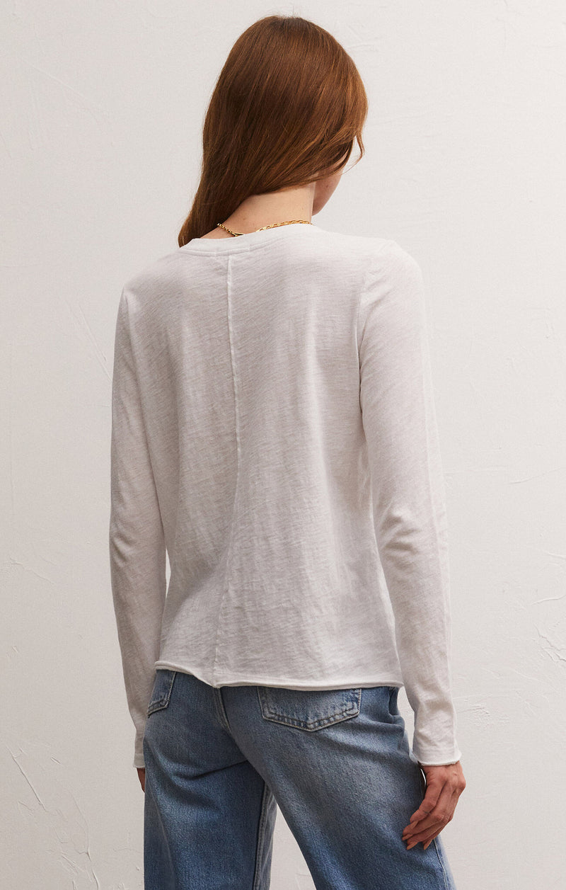 back view of model in shirt. shows rolled hem, relaxed fit and seam down the back.