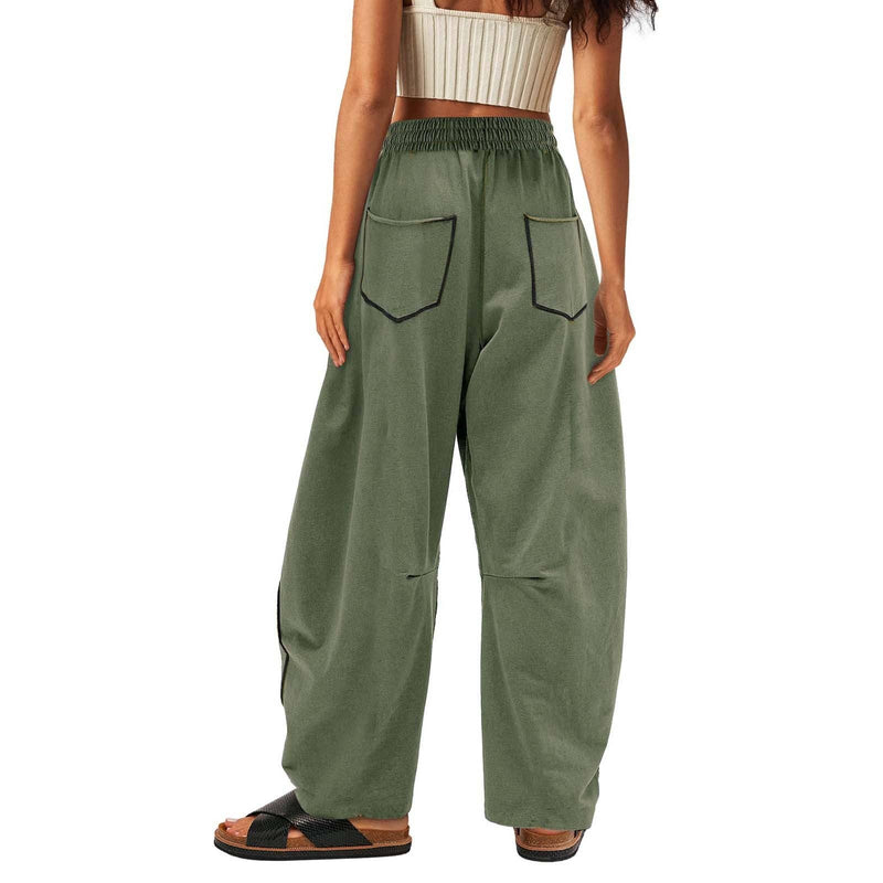 Green wide-leg pants worn by a person on a white background