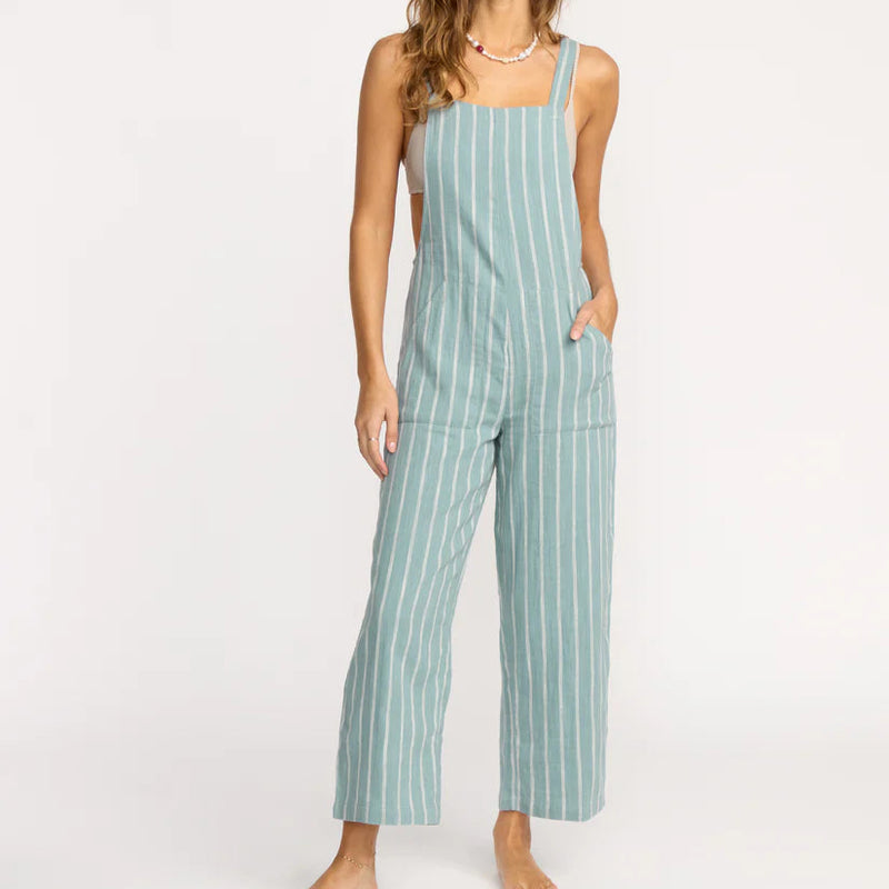 Woman wearing a striped jumpsuit on a white background