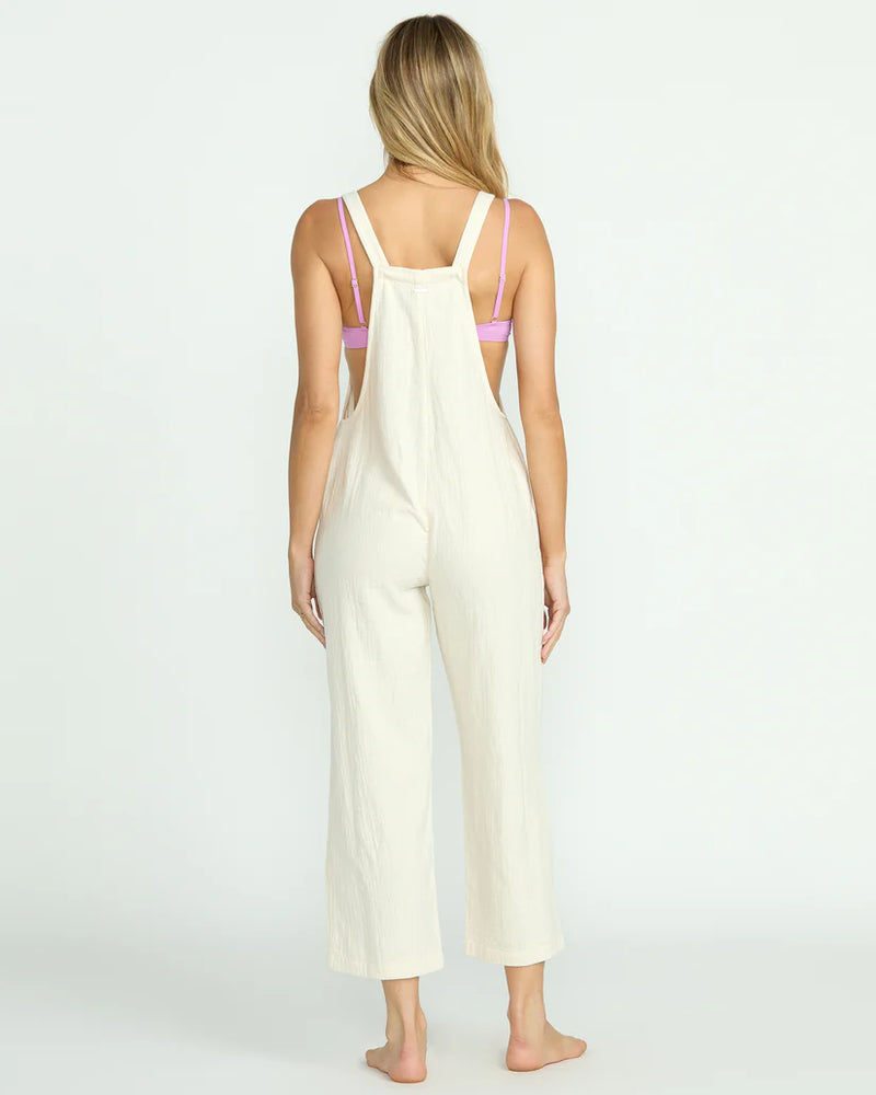 back view of the pacific time jumpsuit. shows the straight leg. also shows the white color and the straps. 