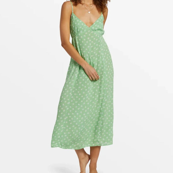 front view of the model wearing the summer shine midi dress. shows the deep v-neckline. also shows the spaghetti straps, the midi length and the floral print. 