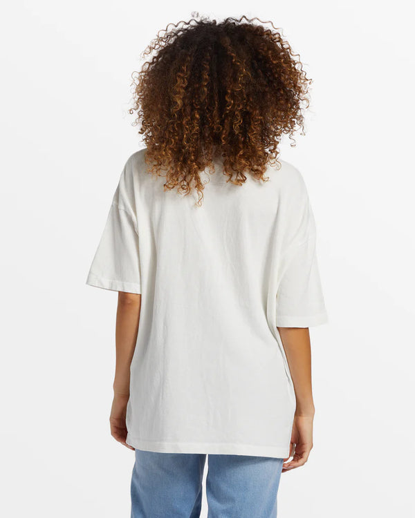 back view of the model wearing the coastal tides oversized t shirt. shows the crew neckline. also shows the oversized fit and the dropped shoulders.