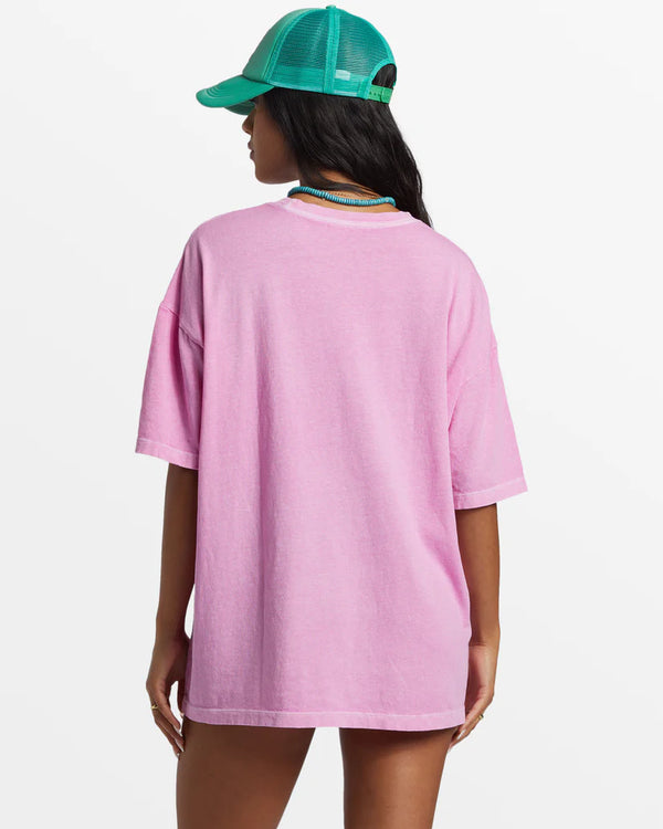 back view of the model wearing the sunrise to sunset oversized t shirt. shows the dropped shoulders. also shows the over sized fit and the crew neckline. 