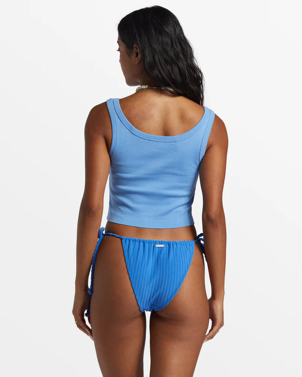 back view of the model wearing the good vibes cropped tank top. shows the wide scoop neckline. also shows the snug fit and the cropped length. 