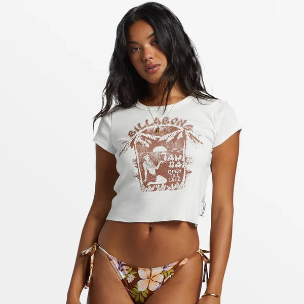 front view of the model wearing the tahiti bar shrunken t shirt. shows the crew neckline. also shows the cropped length, the screen print design and the short sleeves. 