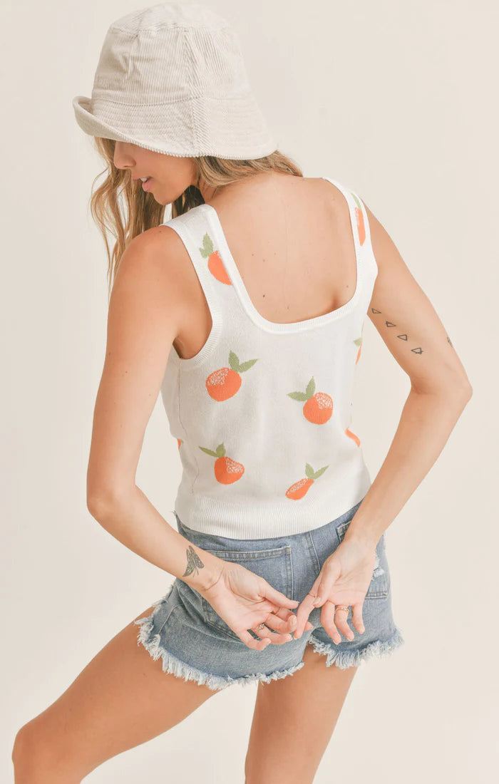 back view of the sweater tank. shows the square back , hits model at the top of her waistband.