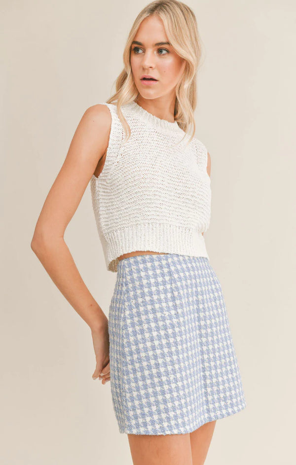 another view of the front of the tank. shows a high neck, sleeveless and cropped length.