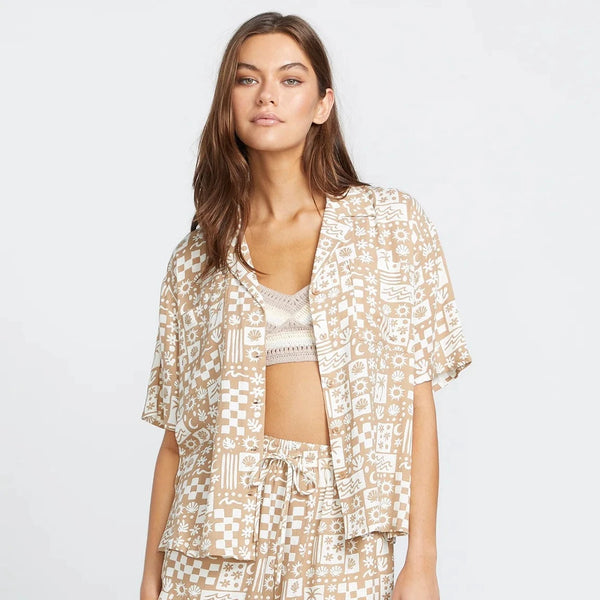 front view of the model wearing the sunny daze shirt. shows the short sleeves. also shows the button down closure, the collar and the all over print. 