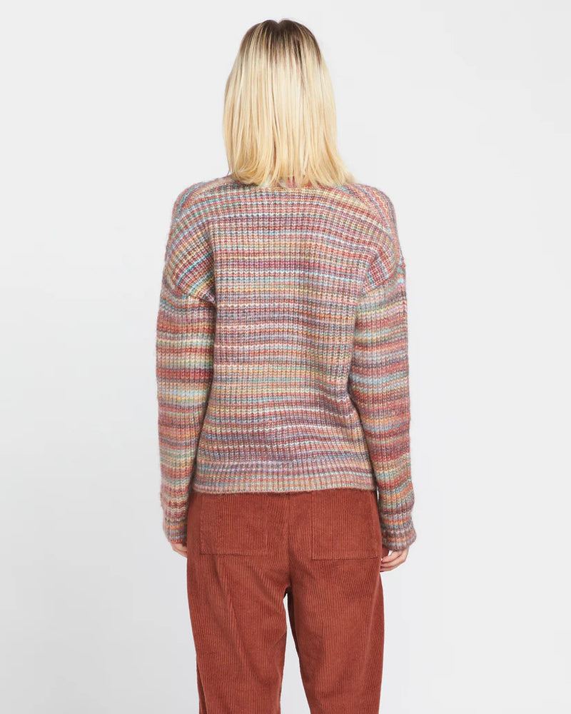 back view of the model wearing the desert dreamz cardi. shows the multi colored stripes. also shows the dropped shoulders, and the oversized fit. 