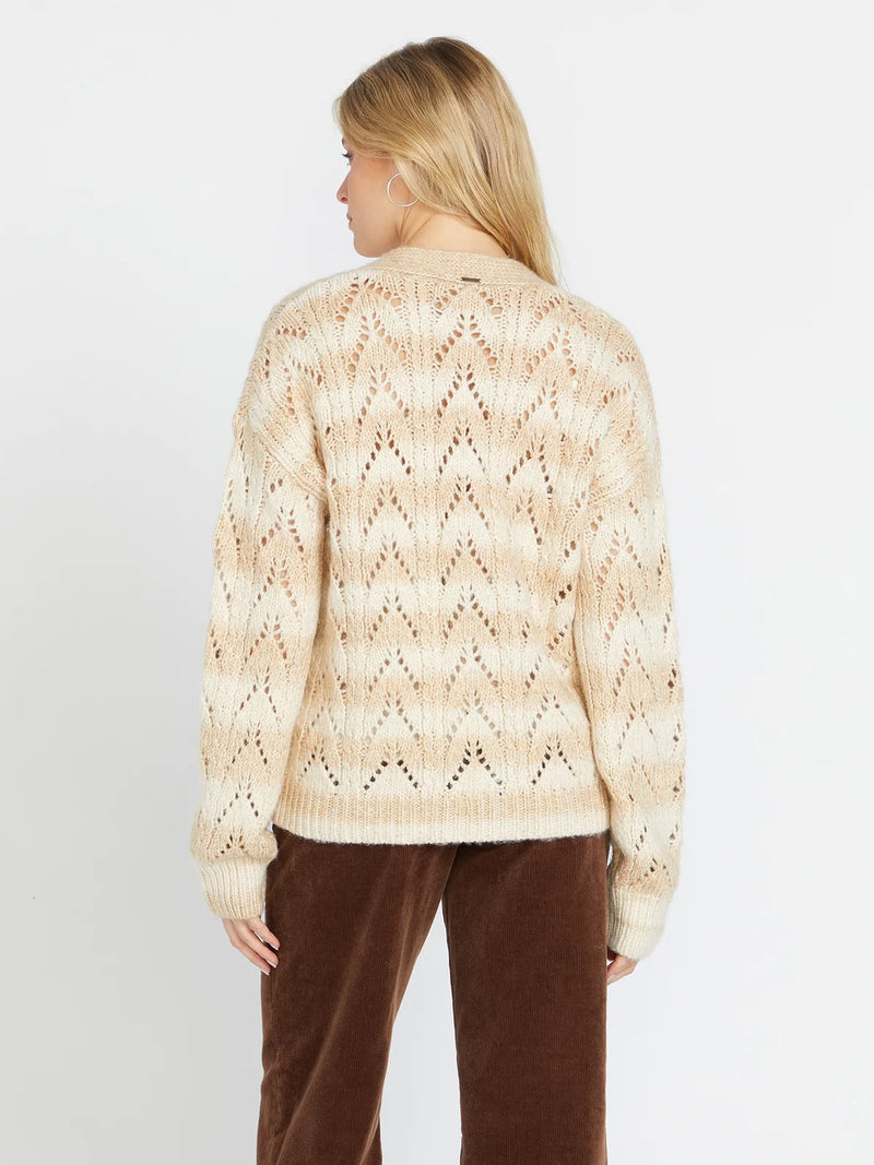 back view of the model wearing the cosmosa cardi in cloud. shows the drop shoulders. also shows the tonal stripe pattern and the oversized fit. 