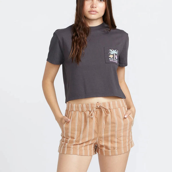 front view of the model wearing the sunday strut shorts. shows the elastic waistband. also shows the drawcord closure, the side pockets and the rolled cuffs. 