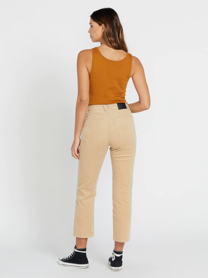 back view of model wearing the stoned straight pants in khaki. shows the back pockets. also shows the the belt loops, the cropped, slight flare bottom and the high rise. 