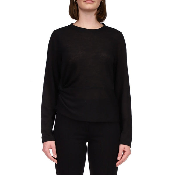 front view of model in black top. shows the crew neckline, long sleeves, and side knot detail.