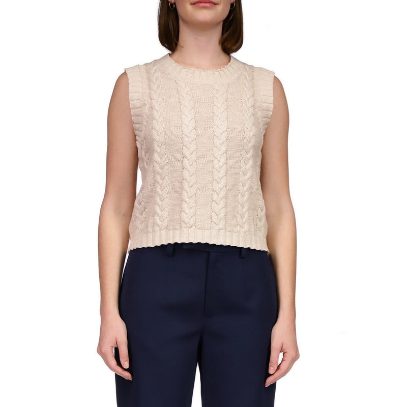 front view of model in sweater vest. shows the crew neckline, sleeveless and cable knit detail.
