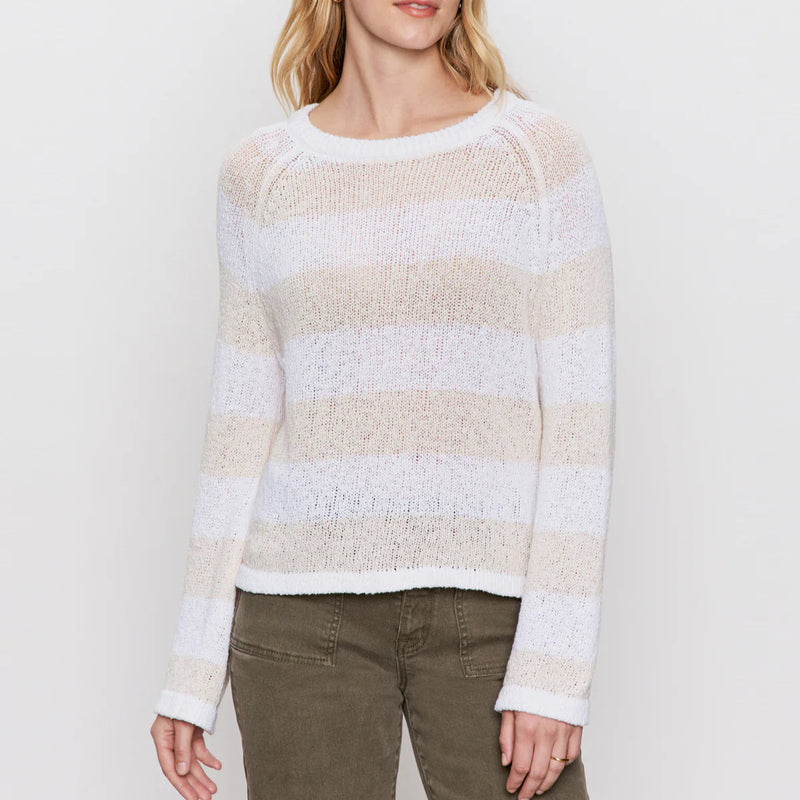 front view of the model wearing the textured raglan crew sweater in white/light oat stripe. shows the crew neckline. also shows the stripe design, the relaxed fit and the breathable fabric. 