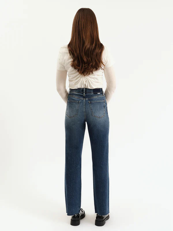 Person wearing blue jeans and a white top on a white background