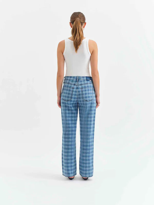 Person wearing blue checkered pants on a white background