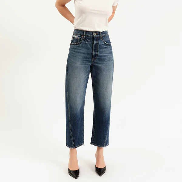 Woman wearing a white t-shirt and blue jeans on a white background