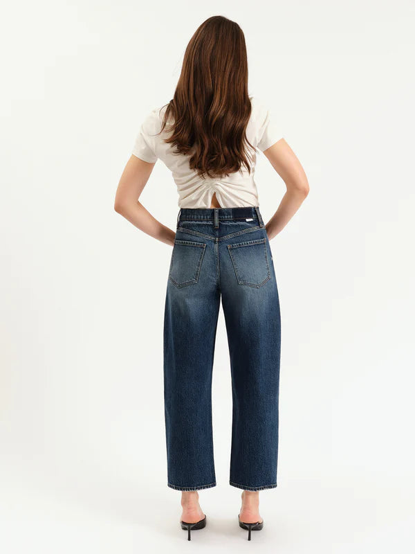 Person wearing blue jeans and a white shirt on a white background
