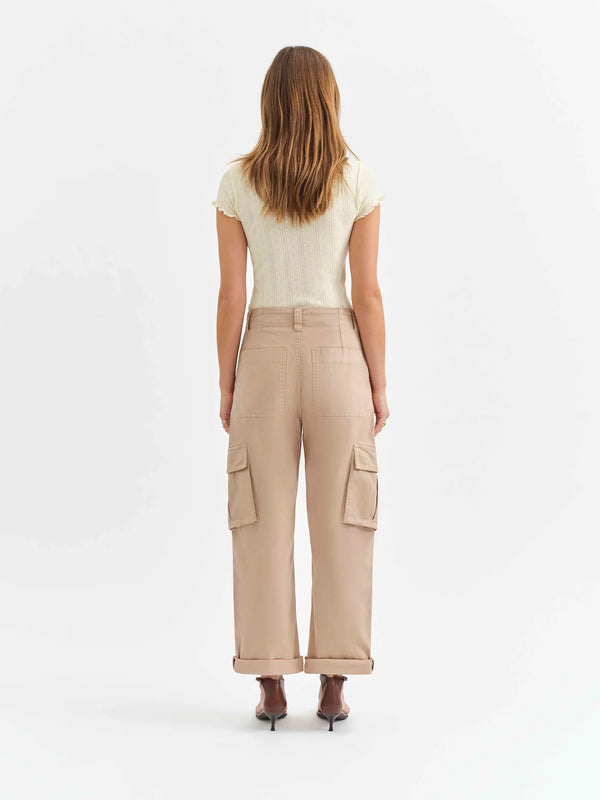 back view of the model wearing the squad curved leg cargo pant. shows the multiple pockets. also shows the rolled cuff and the taupe color. 