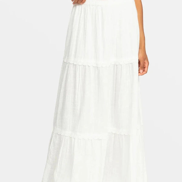 front view of the model wearing the beachside tiered maxi skirt. shows the tiers throughout. also shows the elastic waist band and the lace trim on each tier. 