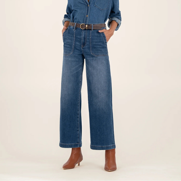 Person wearing a blue denim jeans on a white background