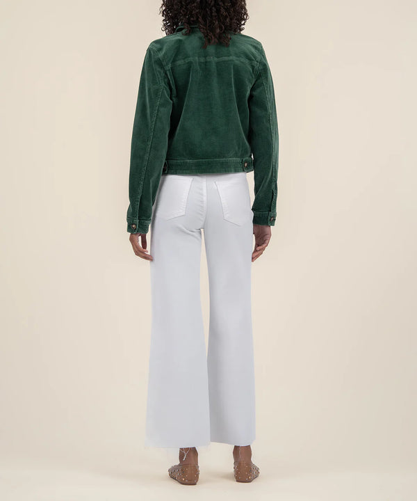 back view of the model wearing the julie corduroy crop jacket. shows the cropped length. also shows the button closure on the cuffs, the defined seaming and the beautiful green color. 
