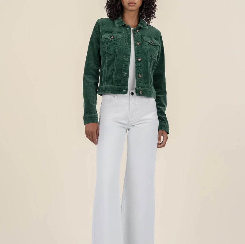 front view of the model wearing the julie corduroy crop jacket. shows the patch pockets. also shows the green color, the button down closure, the cropped length and the corduroy detail. 