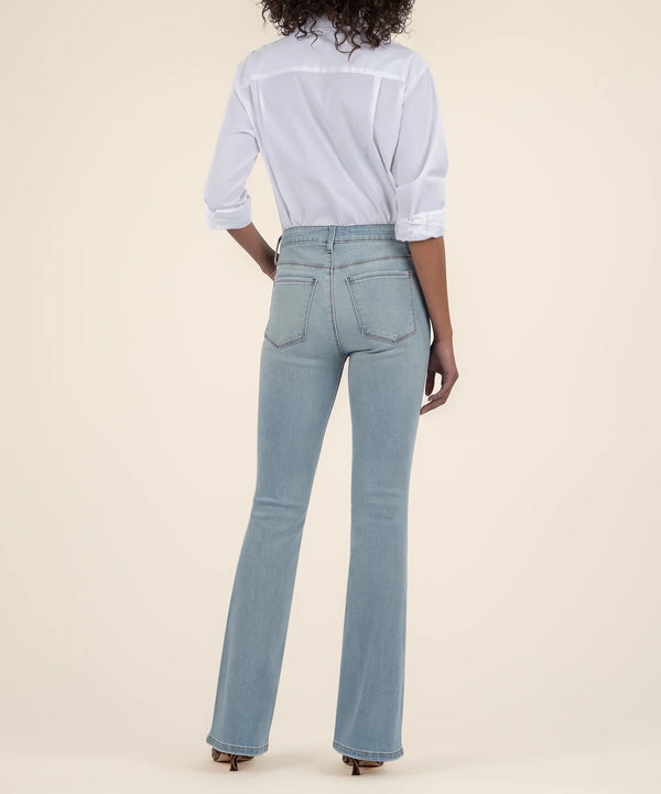 back view of the model wearing the ana high rise flare jean. shows the back pockets. also shows the flared leg, the belt loops, and the high waist. 