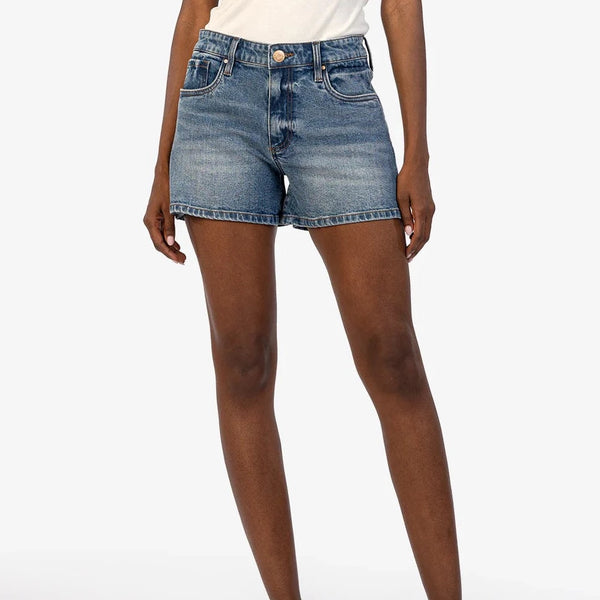 front view of model wearing the jane high rise short. shows the retro high rise. also the button/zipper closure, the midi length and the whisker detailing. 