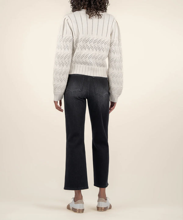back view of the model wearing the mimi scallop neck cardigan, shows the cut detailing. also shows the waist length and the ribbed detailing. 