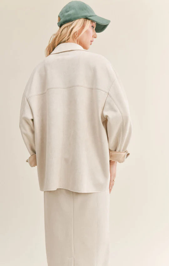 back view of model in shirt. shows oversized fit and horizontal seam running across the back.