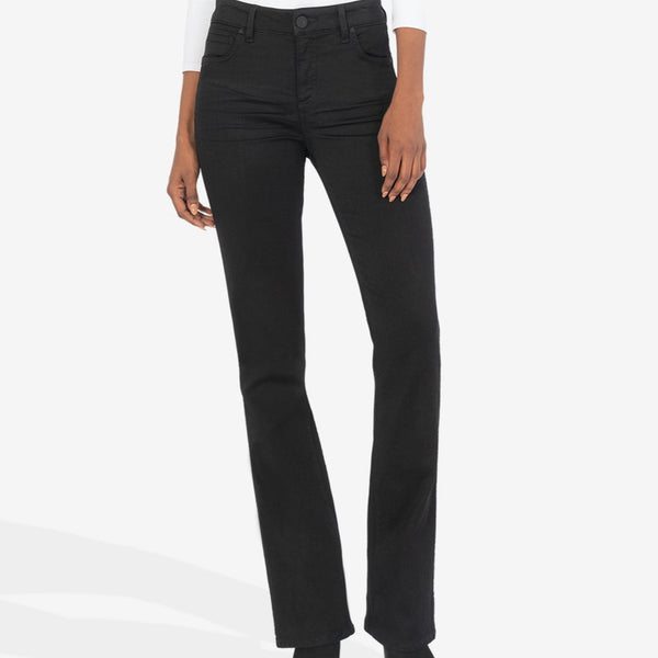 Front view of model wearing pants. Shows the high rise. Also shows the button closure, bootcut style, front pockets, and the black color. 