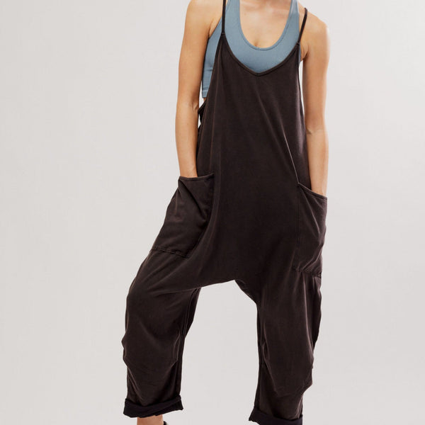 front view of the model wearing the hot shot onesie. shows the oversized front patch pockets. also shows the dropped armholes and the slouchy fit. 